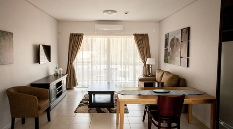Apartments @ 125 - 1 bedroom unit; lounge & dining area including smart enabled TV